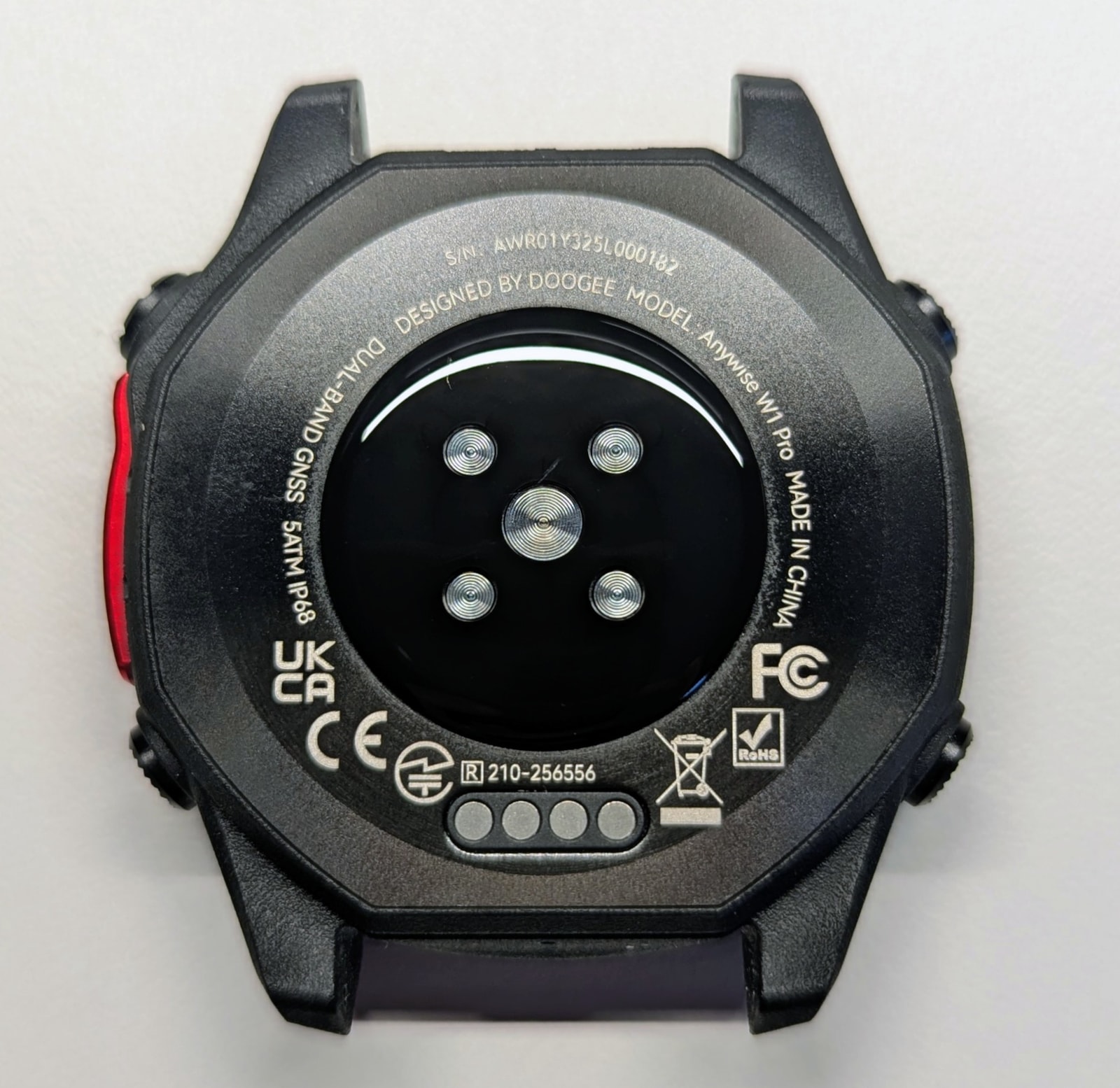 Back of the Anywise W1 Pro showing the optical sensor array and charging contacts