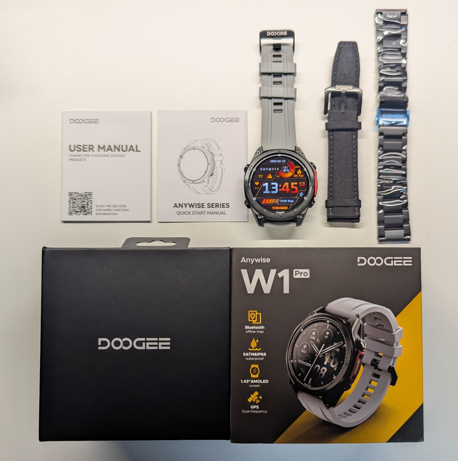 Doogee Anywise W1 Pro retail box with the watch, charger, manuals, screen protector, and extra straps