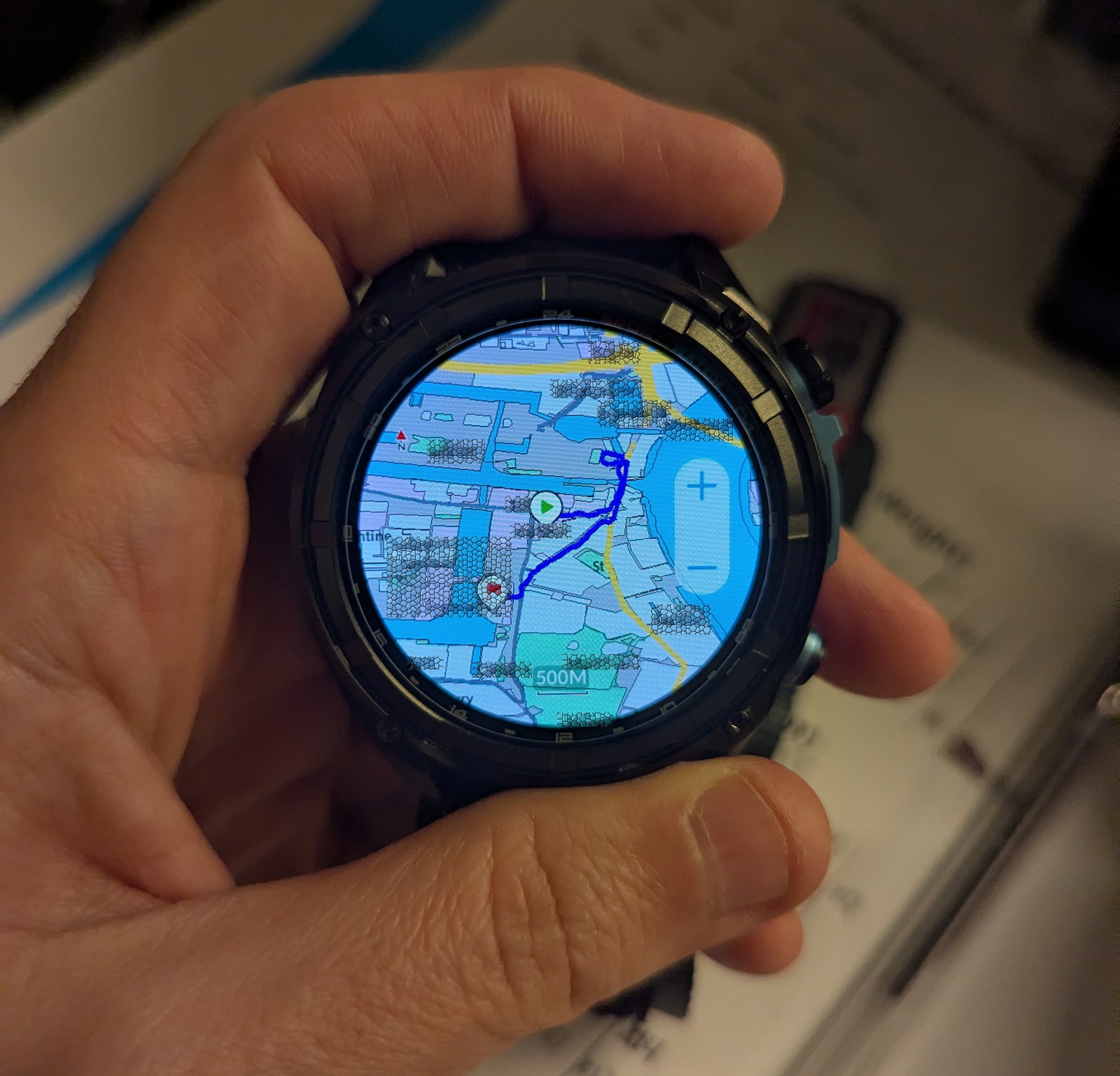 Close-up of the KKTICK Tank T5 offline map screen showing a recorded route line across central and east London with zoom controls on the display
