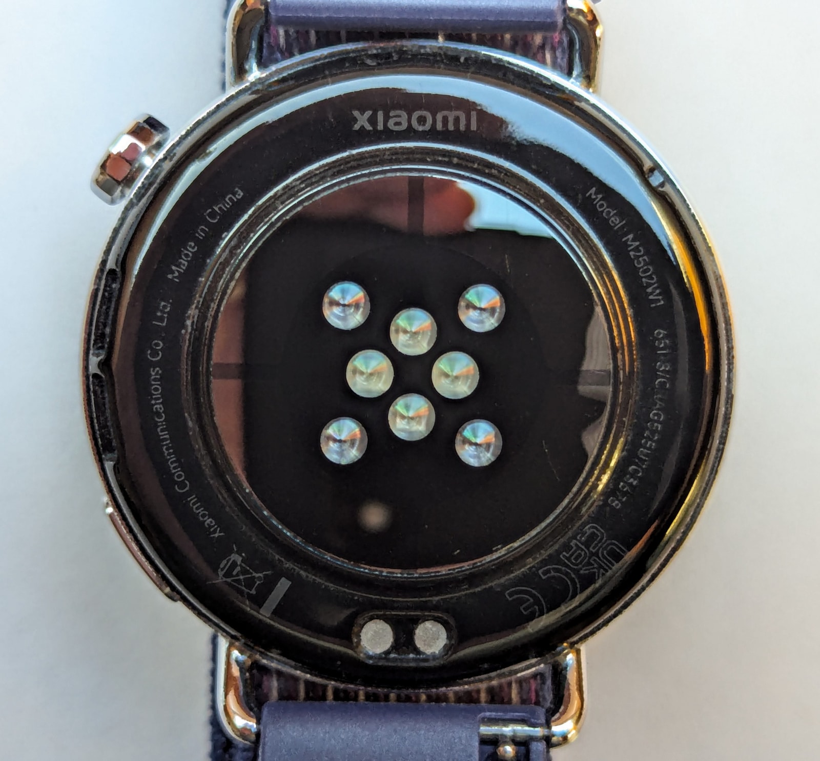 The back of the Xiaomi Watch S4 41mm highlighting the 4-LED heart rate sensor array and charging pins